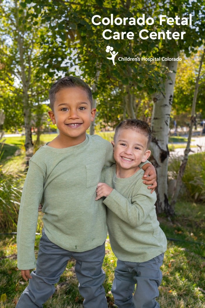 2330187f-516f-489b-b707-96888cbe9568 Smiling young brothers wrap each other in a hug