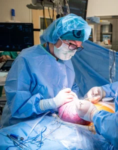 Doctor in surgical scrubs operates on pregnant woman