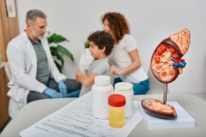Doctor talks to boy and his mom about his health in an exam room