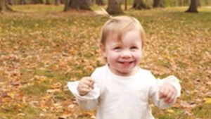 Grace as a toddler, smiling and walking independently