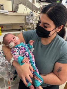 Mom with Maya in the NICU