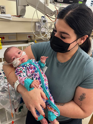 Mom with Maya in the NICU